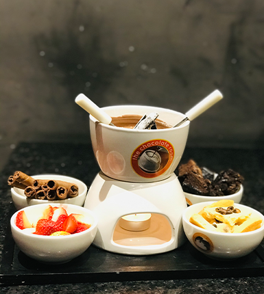 Indulge in chocolate fondue at a dessert and chocolate shop franchise cafe in Ahmedabad.